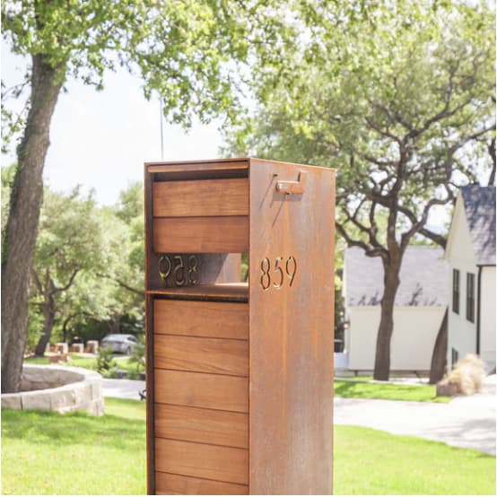 Modern steel mailbox with a rusted patina
